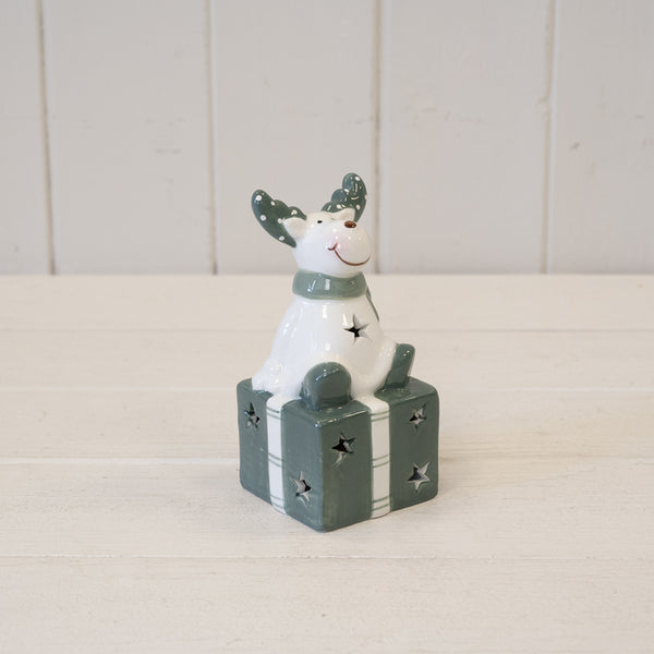 Nordic Green Reindeer sitting on LED Present