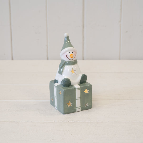 Nordic Green Snowman sitting on LED Present