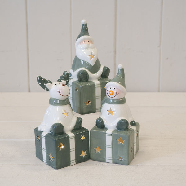 Nordic Green Snowman sitting on LED Present