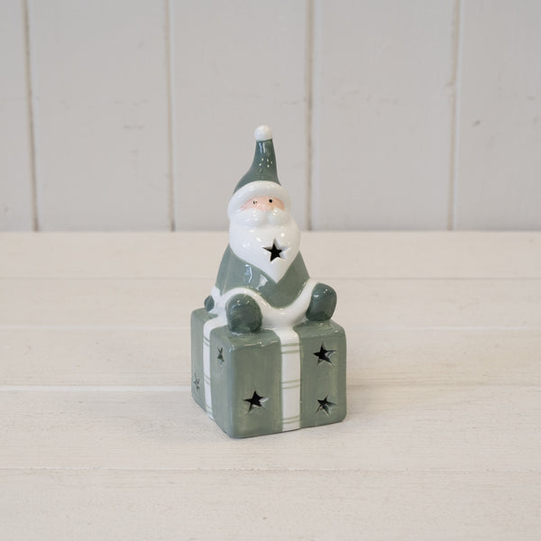 Nordic Green Santa sitting on LED Present