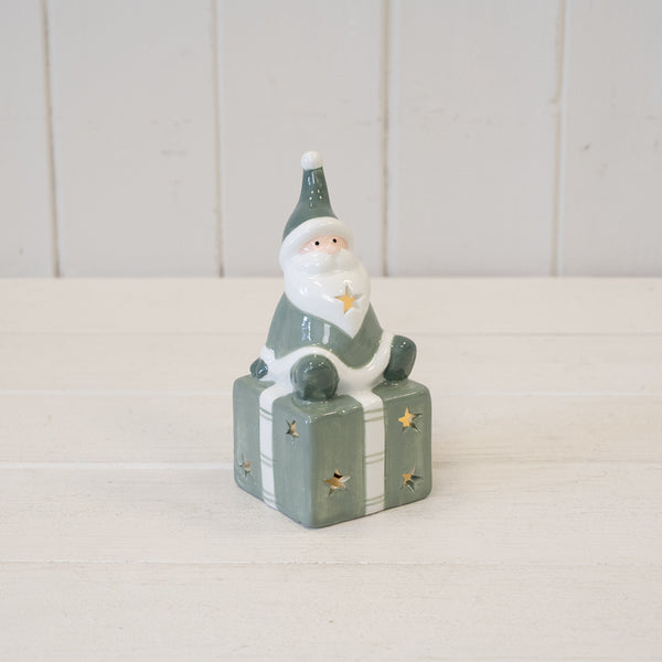 Nordic Green Santa sitting on LED Present